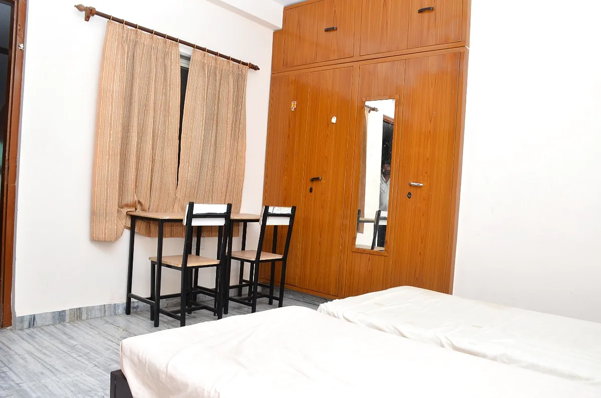 Room with spacious wardrobe, mirror, study table and window